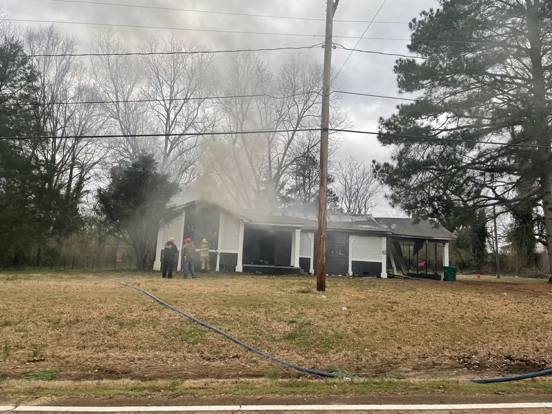Residential house fully engulfed in flames during a structure fire